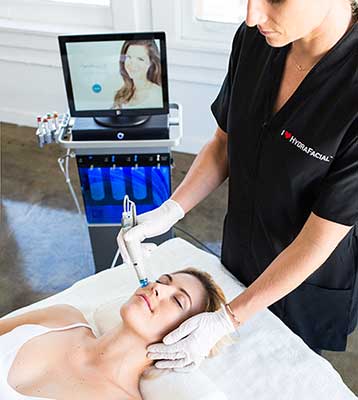 woman receiving a hydrafacial