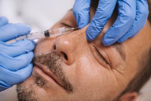 man getting injectable treatment on his face
